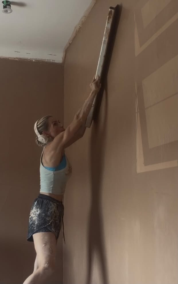Holly ruling in a wall to get it dead flat